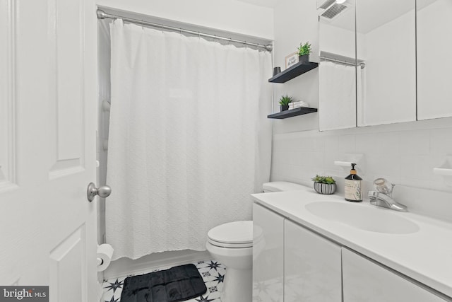 full bathroom featuring toilet, vanity, and backsplash