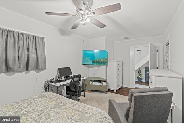 bedroom with ornamental molding, a ceiling fan, an office area, and baseboards