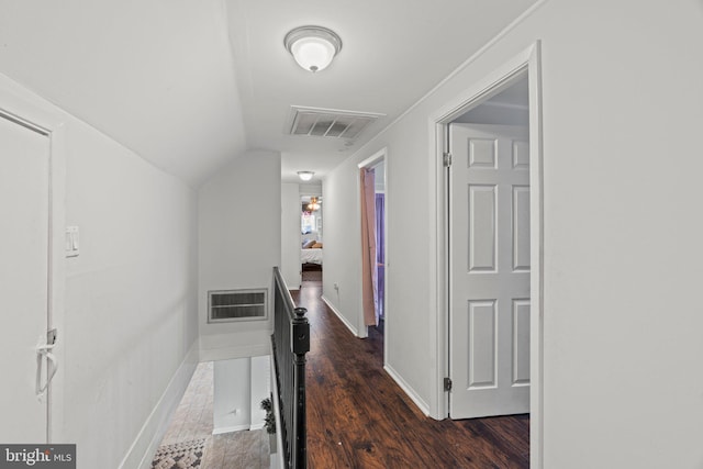 corridor featuring an upstairs landing, dark wood-style floors, lofted ceiling, and baseboards