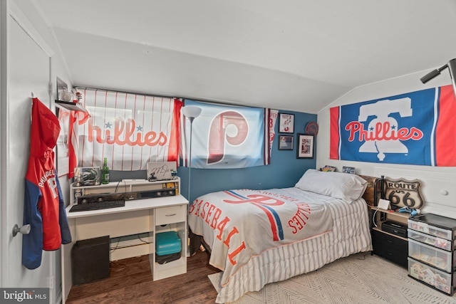 bedroom featuring vaulted ceiling and wood finished floors