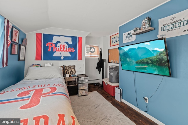 bedroom with wood finished floors, a baseboard radiator, and lofted ceiling