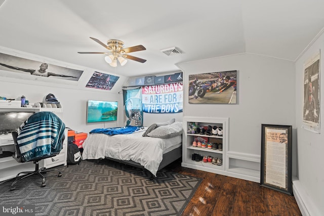 bedroom featuring wood finished floors, vaulted ceiling, and a ceiling fan