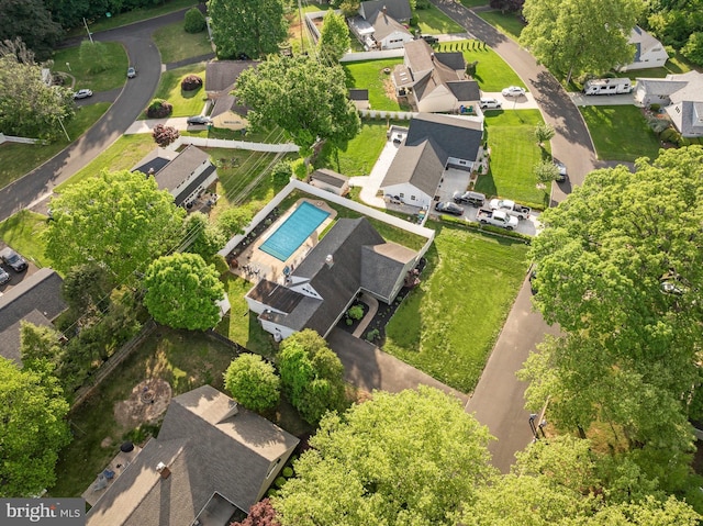 aerial view of property's location with nearby suburban area and a pool area