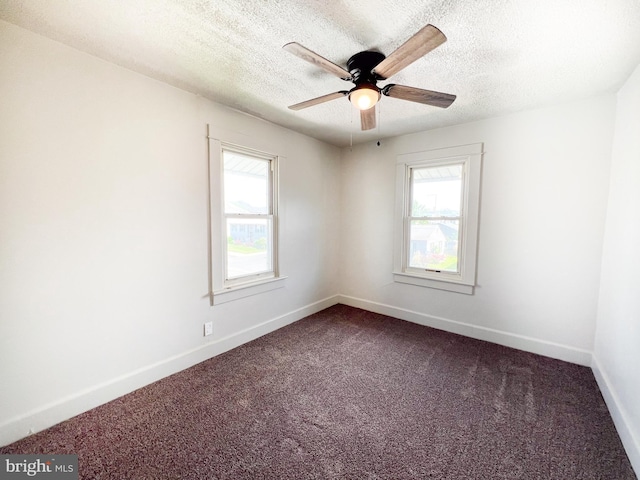 502 S Wayne St, Lewistown, PA 17044 - empty room with healthy amount of natural light, dark colored carpet, a ceiling fan, baseboards, and a textured ceiling