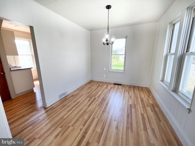 502 S Wayne St, Lewistown, PA 17044 - unfurnished dining area with light wood-style flooring, a chandelier, and baseboards