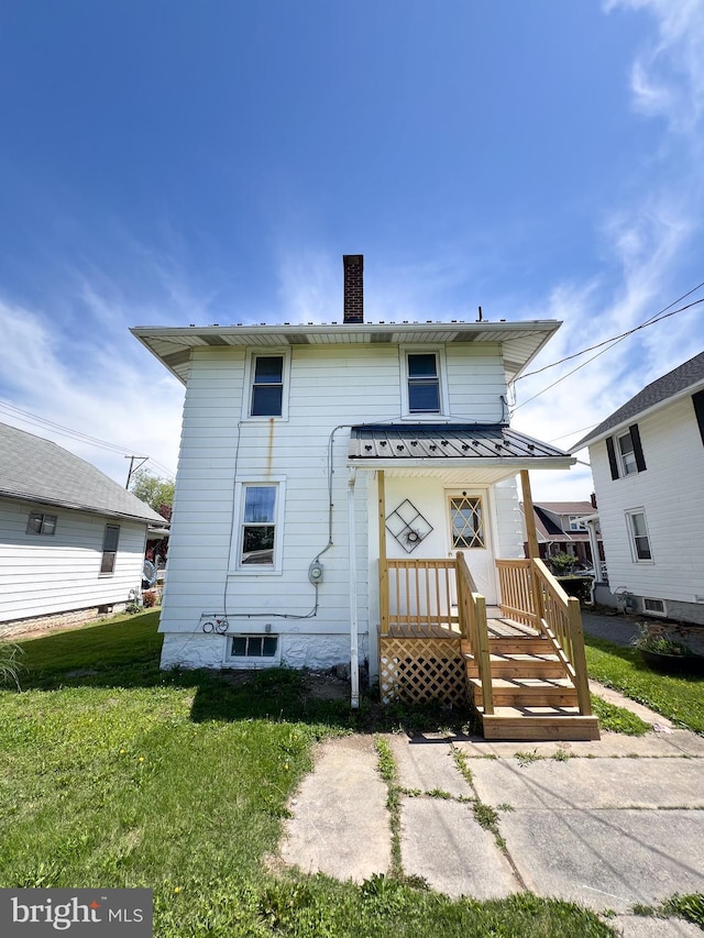 502 S Wayne St, Lewistown, PA 17044 - back of house with a chimney, a yard, metal roof, and a standing seam roof