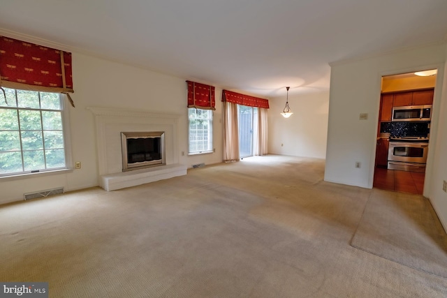 8803 Duveen Dr, Glenside, PA 19038 - unfurnished living room featuring light colored carpet, a glass covered fireplace, and crown molding