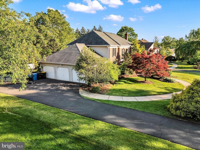 102 Windsong Dr, Doylestown, PA 18901 - view of home's exterior featuring asphalt driveway, a lawn, a chimney, and an attached garage