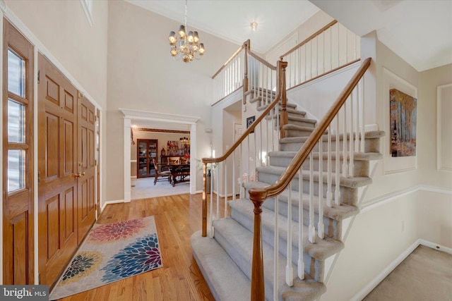 102 Windsong Dr, Doylestown, PA 18901 - entrance foyer featuring stairs, a chandelier, baseboards, wood finished floors, and a towering ceiling