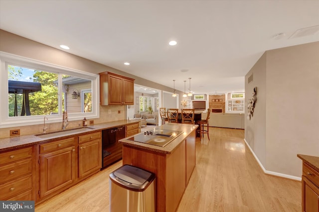 102 Windsong Dr, Doylestown, PA 18901 - kitchen with black appliances, a sink, open floor plan, light wood finished floors, and a kitchen island