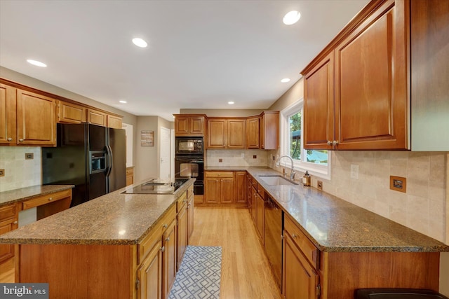 102 Windsong Dr, Doylestown, PA 18901 - kitchen featuring black appliances, a sink, light wood-style flooring, tasteful backsplash, and recessed lighting