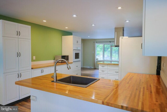 175 Mountain Heights Rd, Front Royal, VA 22630 - kitchen featuring butcher block countertops, a sink, white appliances, recessed lighting, and white cabinetry