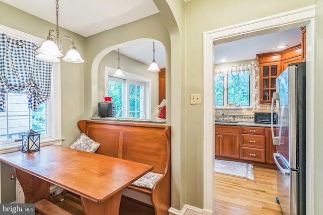 6427 Woodcrest Ave, Philadelphia, PA 19151 - dining area featuring arched walkways, light wood finished floors, and healthy amount of natural light