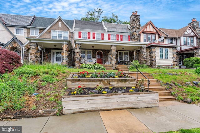6427 Woodcrest Ave, Philadelphia, PA 19151 - view of front of property with a vegetable garden, a chimney, a porch, and stone siding