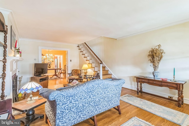 6427 Woodcrest Ave, Philadelphia, PA 19151 - living area with stairs, ornamental molding, wood finished floors, a chandelier, and baseboards