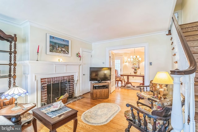 6427 Woodcrest Ave, Philadelphia, PA 19151 - living room featuring a fireplace, light wood-type flooring, crown molding, stairs, and a chandelier