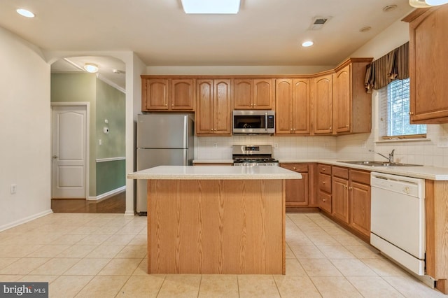 1 Grande Blvd, West Windsor, NJ 08550 - kitchen featuring stainless steel appliances, light countertops, decorative backsplash, light tile patterned floors, and a kitchen island