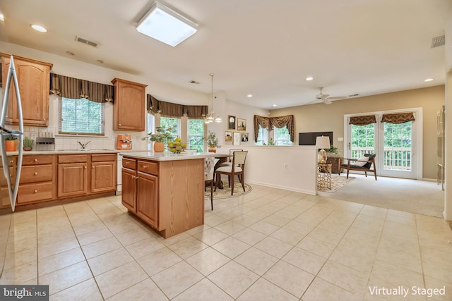 1 Grande Blvd, West Windsor, NJ 08550 - kitchen featuring light countertops, a kitchen breakfast bar, light tile patterned flooring, healthy amount of natural light, and recessed lighting