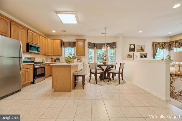 1 Grande Blvd, West Windsor, NJ 08550 - kitchen featuring stainless steel appliances, light countertops, plenty of natural light, a kitchen breakfast bar, and recessed lighting