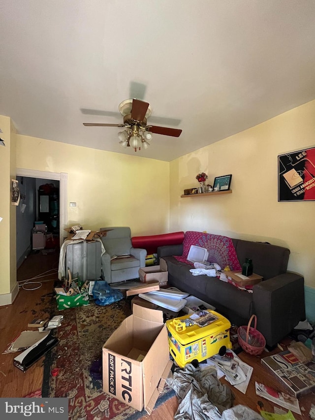 living area featuring a ceiling fan and wood finished floors