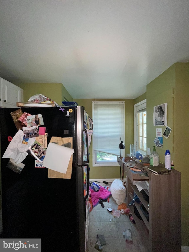bedroom featuring freestanding refrigerator
