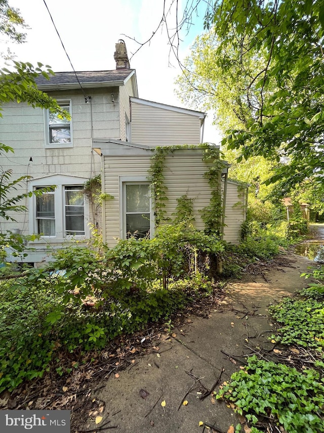 view of side of home featuring a chimney