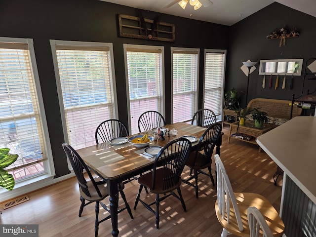 dining area with wood finished floors and a ceiling fan