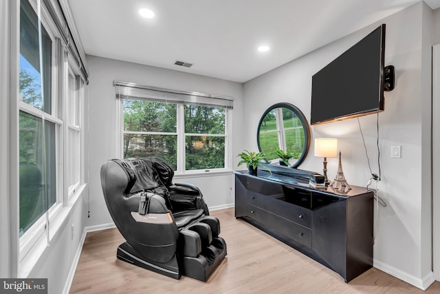 sitting room featuring baseboards, light wood-type flooring, and recessed lighting