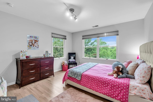 bedroom featuring light wood-style floors and baseboards