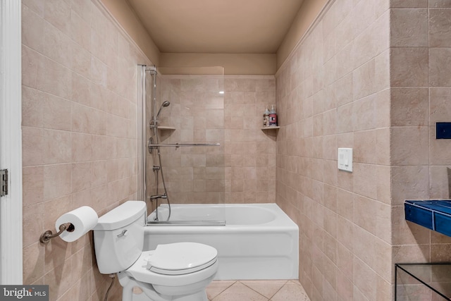 bathroom featuring tile walls, toilet, tile patterned floors, and shower / washtub combination