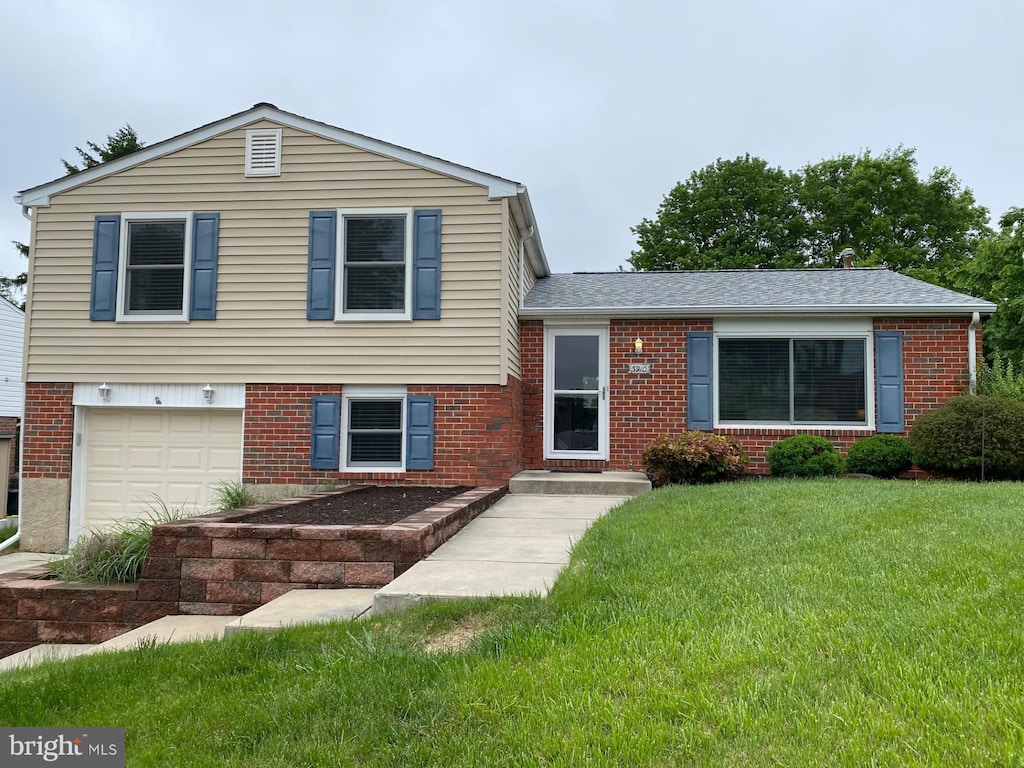 3910 Klausmier Rd, Nottingham, MD 21236 - split level home with brick siding, a front lawn, and an attached garage