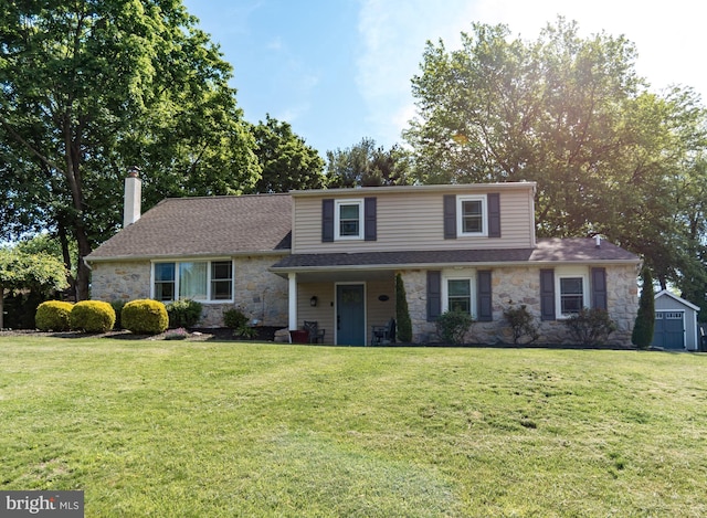 303 N Elm Ave, Newtown, PA 18940 - view of front of house featuring stone siding, a chimney, and a front lawn
