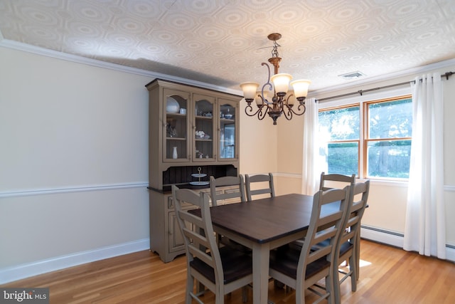 303 N Elm Ave, Newtown, PA 18940 - dining space featuring light wood-style floors, an ornate ceiling, a chandelier, and baseboards