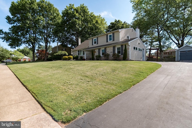 303 N Elm Ave, Newtown, PA 18940 - traditional home featuring a chimney, a front yard, and an outbuilding