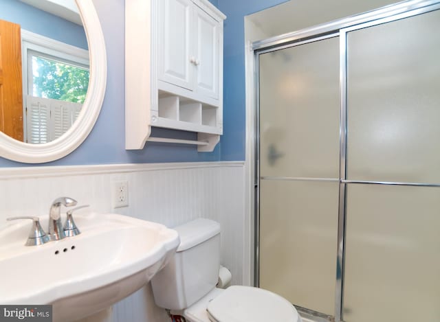 303 N Elm Ave, Newtown, PA 18940 - bathroom featuring a sink, a wainscoted wall, a stall shower, and toilet