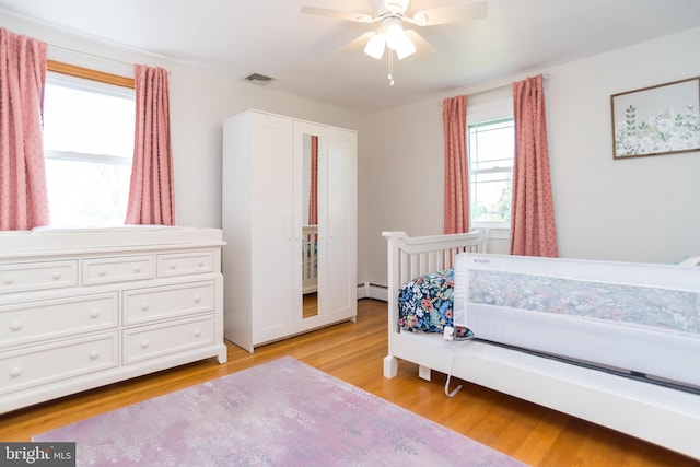 303 N Elm Ave, Newtown, PA 18940 - bedroom featuring a baseboard radiator, light wood finished floors, and a ceiling fan