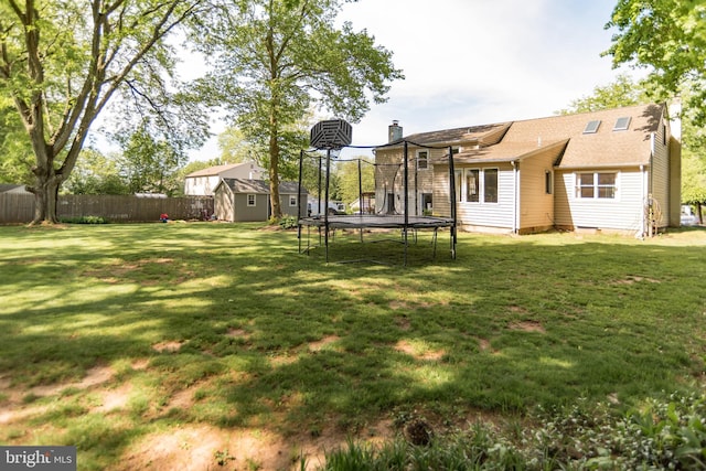 303 N Elm Ave, Newtown, PA 18940 - back of property featuring a trampoline, a shed, an outbuilding, and a chimney
