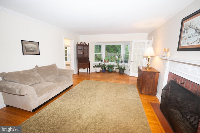 525 Croyden Rd, Cheltenham, PA 19012 - living room with crown molding, light wood finished floors, and a brick fireplace