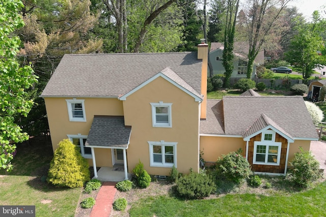 525 Croyden Rd, Cheltenham, PA 19012 - traditional-style house featuring stucco siding, a chimney, a shingled roof, and a front yard