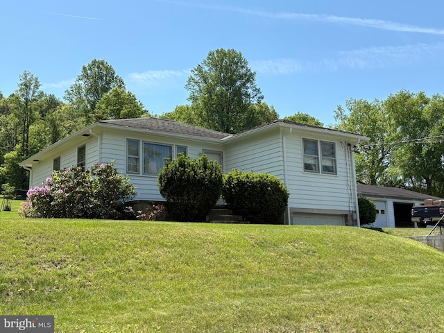 view of front of home with a garage and a front lawn