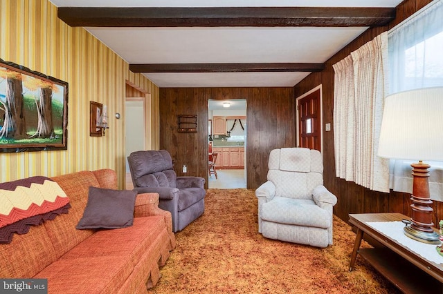 living room featuring beam ceiling, wallpapered walls, wooden walls, and carpet floors