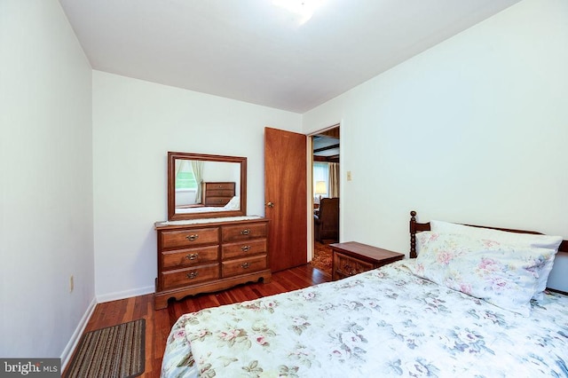 bedroom featuring wood finished floors and baseboards
