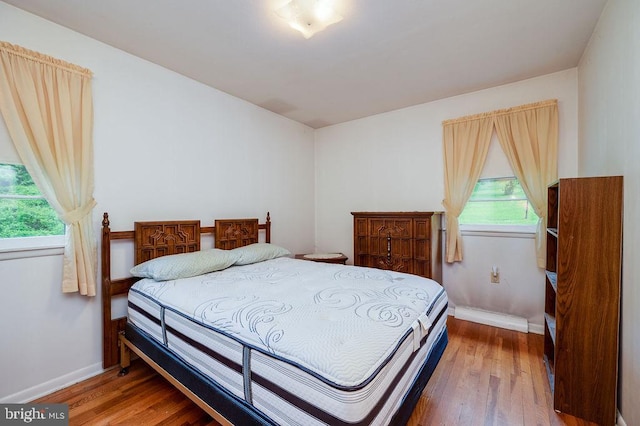 bedroom with wood finished floors and baseboards