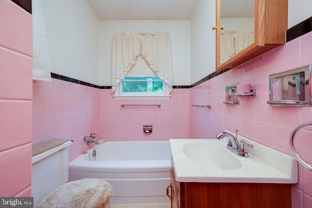 bathroom with tile walls, a garden tub, vanity, and wainscoting