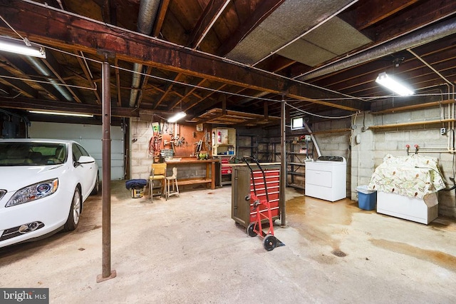 unfinished below grade area with a workshop area and separate washer and dryer