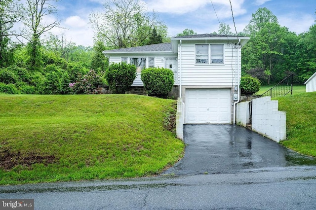 tri-level home featuring asphalt driveway, an attached garage, and a front lawn
