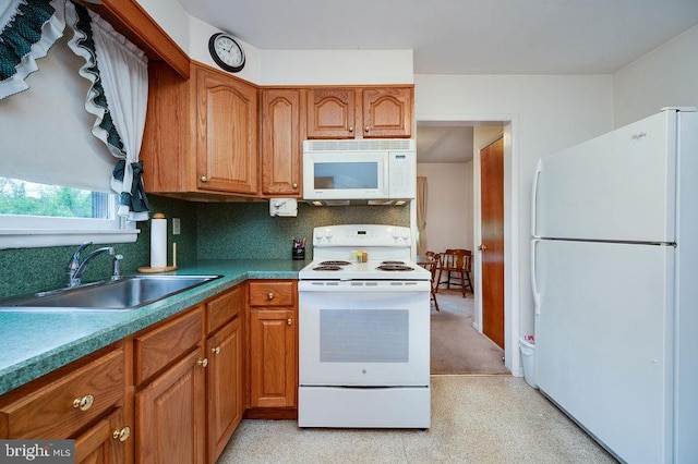 kitchen featuring white appliances, a sink, brown cabinetry, and tasteful backsplash