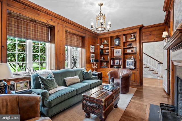 1182 Wrack Rd, Meadowbrook, PA 19046 - living room with a chandelier, wood walls, stairs, light wood finished floors, and a fireplace with flush hearth