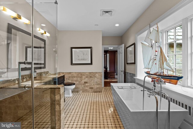 1182 Wrack Rd, Meadowbrook, PA 19046 - bathroom with a wainscoted wall, a freestanding tub, tile walls, toilet, and vanity