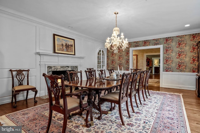 1182 Wrack Rd, Meadowbrook, PA 19046 - dining space featuring a decorative wall, a chandelier, wood finished floors, crown molding, and a fireplace